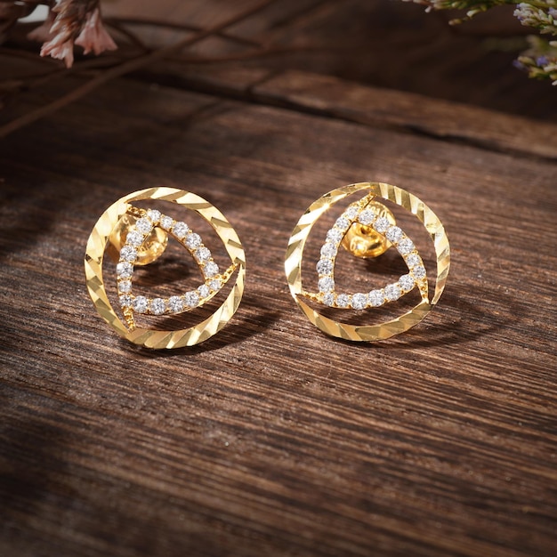 Gold Pierced Earrings on background wood