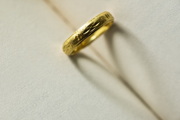 gold ring with shadow heart shape on the book page