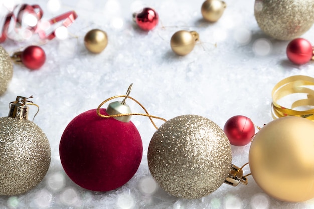 Gold shiny and red balls for a New Year Christmas tree on a white background with space for text Layout of a postcard poster