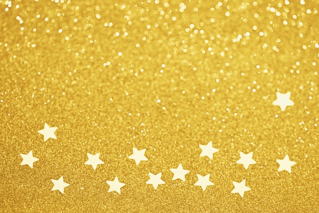 Gold star confetti glitter holiday decoration, defocused bokeh lights