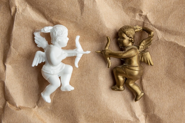 gold and white cupid on a background of kraft paper