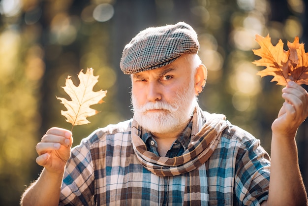 Golden age grandfather portrait of a senior autumn man outdoors portrait of handsome old man elderly...