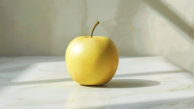 a golden apple is on a white surface with a shadow behind it