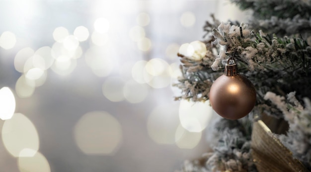 Golden ball on christmas tree with bokeh background