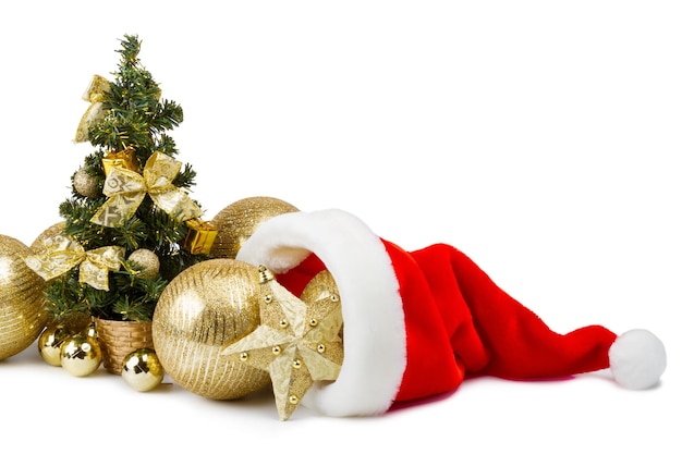 Golden baubles in Santa Claus hat and Christmas tree