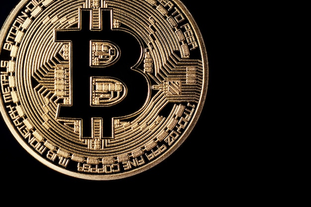 Golden bitcoin on black background. Bitcoin cryptocurrency.