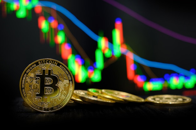 Golden bitcoin cryptocurrency at trading chart background