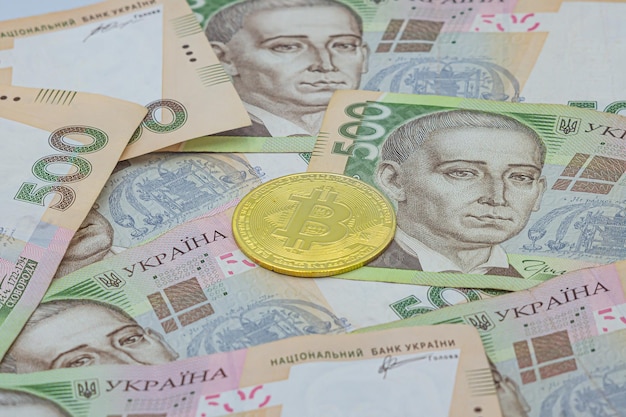 Golden bitcoin on five hundred ukrainian hryvnia bills background Bitcoin in Ukraine Bitcoin exchange Bitcoin exchange rate to Ukrainian currency Use of blockchain technology in Ukraine