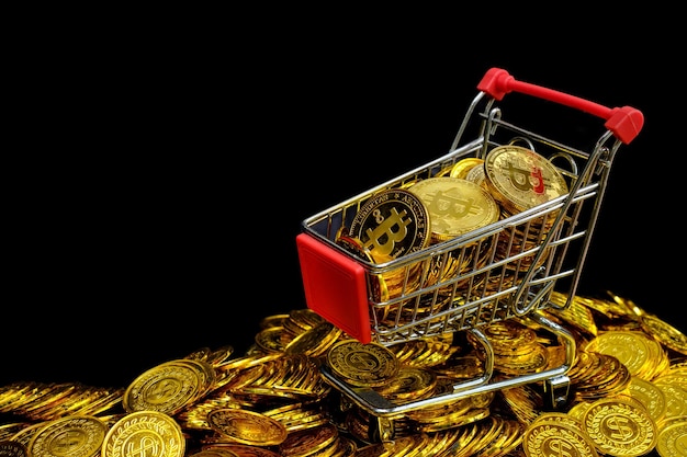 Golden bitcoins in the shopping cart on a stacking gold coin at black background