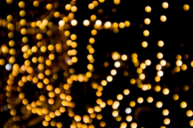 Golden bokeh on a black ,blurred garland light