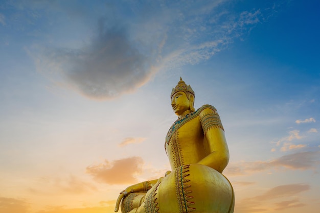 Golden buddha,Big Buddha statue outdoors,The giant golden Buddha. The large buddha statue with sunse