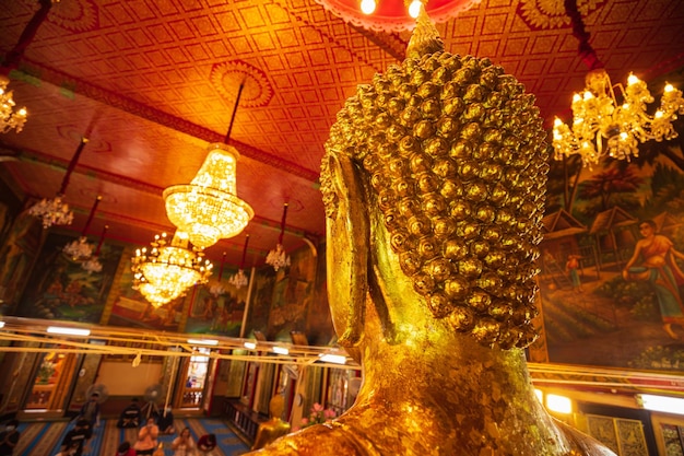 Golden Buddha behind faces statue meditation sitting