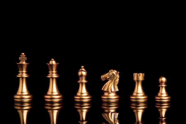 Golden chess include king queen horse ship and pawn on black background with reflection.