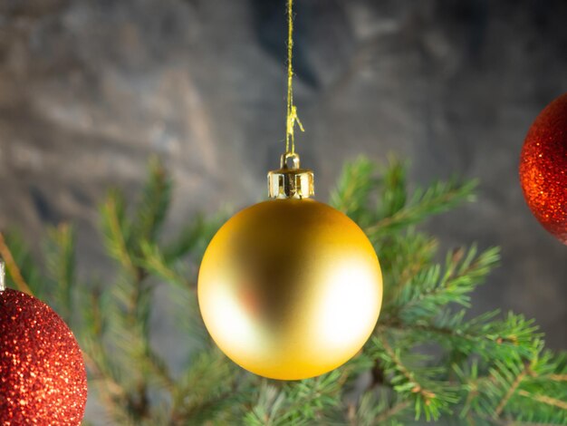 Golden Christmas ball on the background of fir branches Christmas decoration