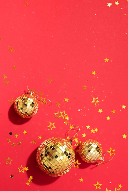 golden christmas balls with shiny stars on red background