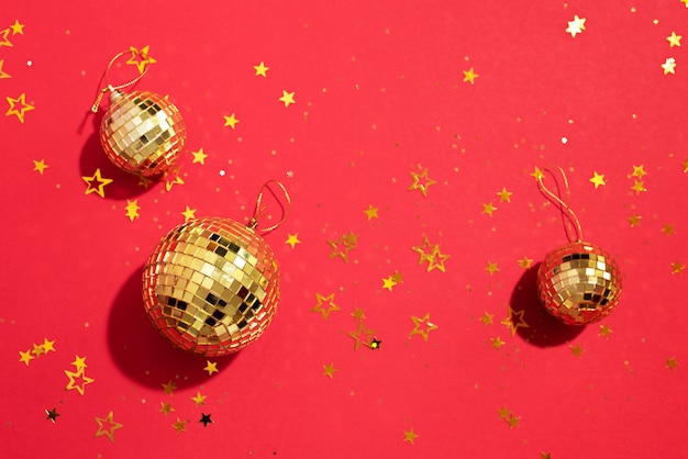 golden christmas balls with shiny stars on red background