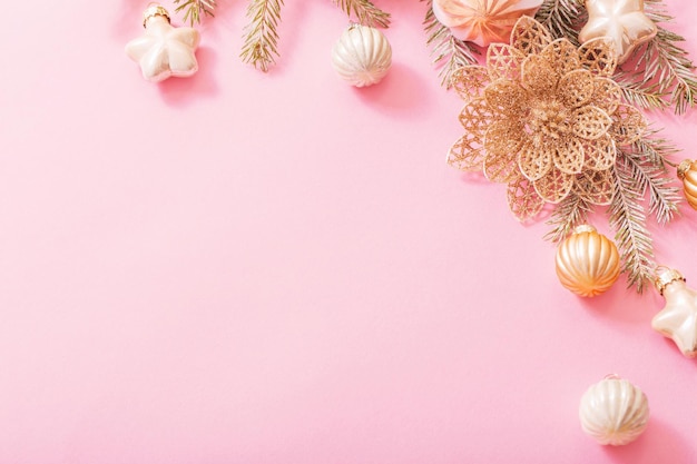 Golden christmas decorations on pink background