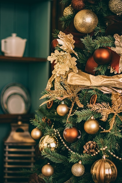 Golden Christmas tree look, decor in country style as holiday home decorations