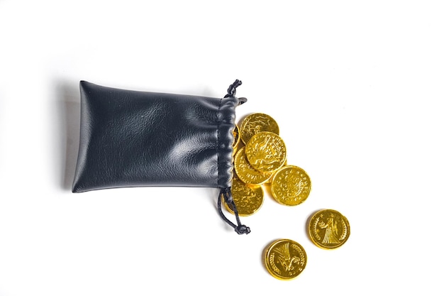 Golden coins money in a black bag on background Focus in the center