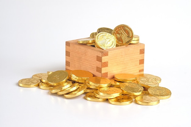 Golden coins money in a wood box on background Focus in the center