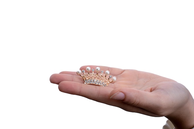 Golden color crown with pearls in hand