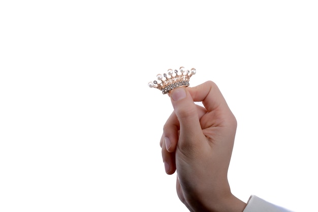 Golden color crown with pearls in hand