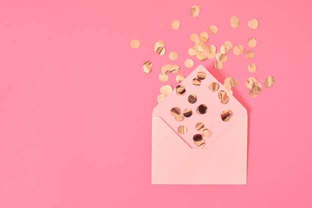 Golden confetti pink paper blank envelope on a pink background congratulation concept