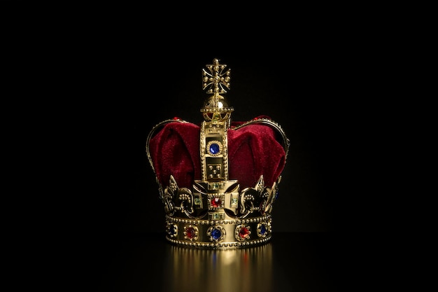 Golden crown on a black background with copy space