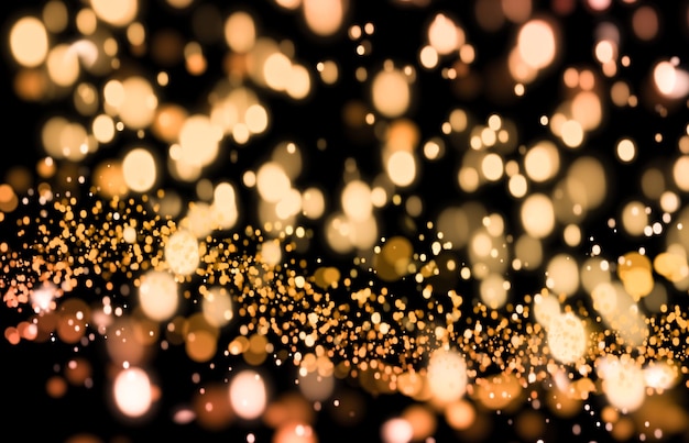 golden defocused lights on a black background. glitter