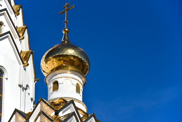 Golden domes of the Orthodox church against the blue sky