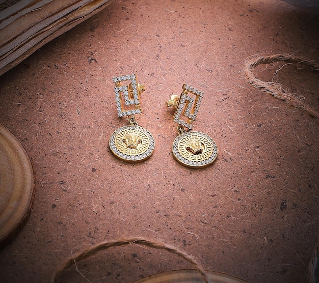 Golden earrings isolated with white crystals and diamonds Beautiful earrings on white background