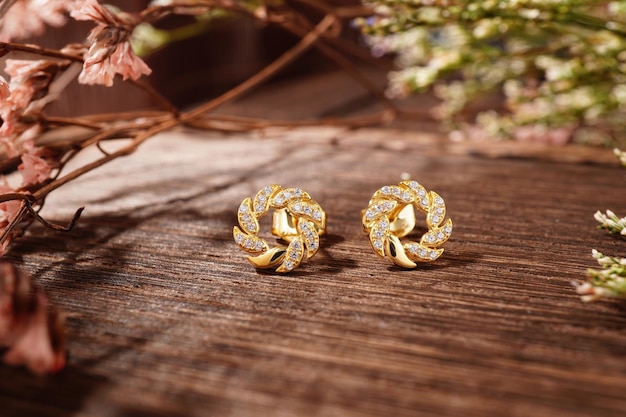 Golden earrings isolated, with white crystals and diamonds. Beautiful earrings on white background