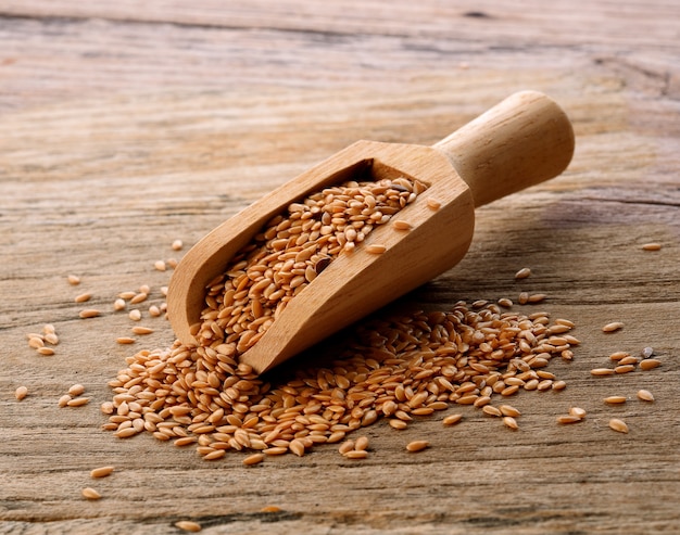 Golden Flax Seeds In Spoon Wood On Wooden table