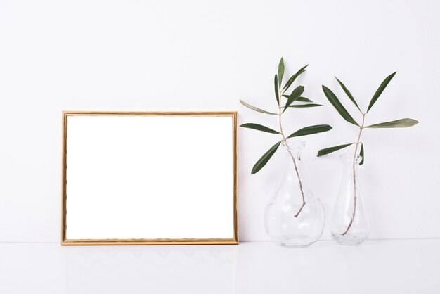 Golden frame mockup on white wall