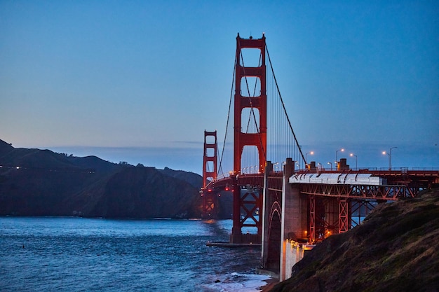 Golden Gate Bridge after sunset with soft light and ocean