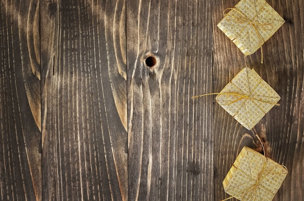 Golden gift boxes on a wooden background