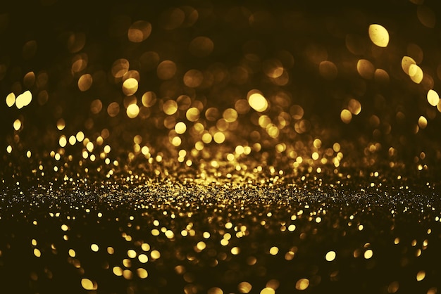 Golden glitter bokeh lighting texture Blurred abstract background for birthday anniversary wedding new year eve or Christmas