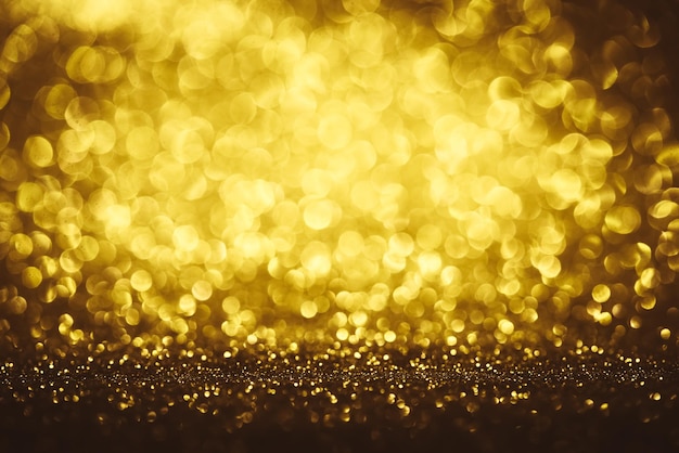 Golden glitter bokeh lighting texture Blurred abstract background for birthday anniversary wedding new year eve or Christmas