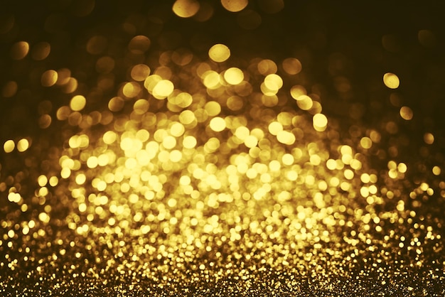 Golden glitter bokeh lighting texture Blurred abstract background for birthday anniversary wedding new year eve or Christmas