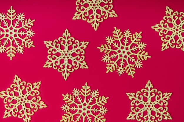 Golden glitter decorative snowlakes on red background Christmas and New Year wallpaper