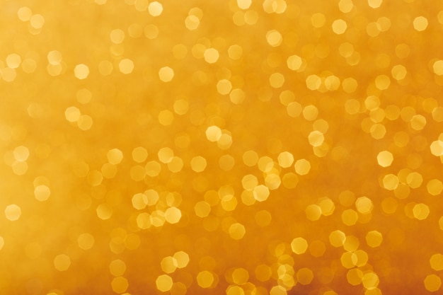 Golden glowing sparkles blurred background