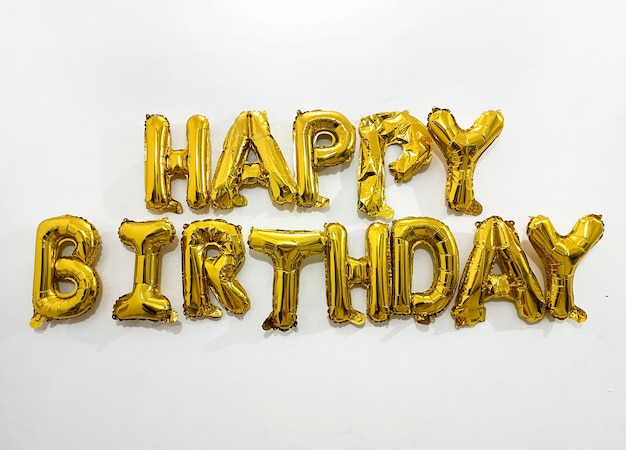 The Golden HAPPY BIRTHDAY words made of inflatable balloons on white background