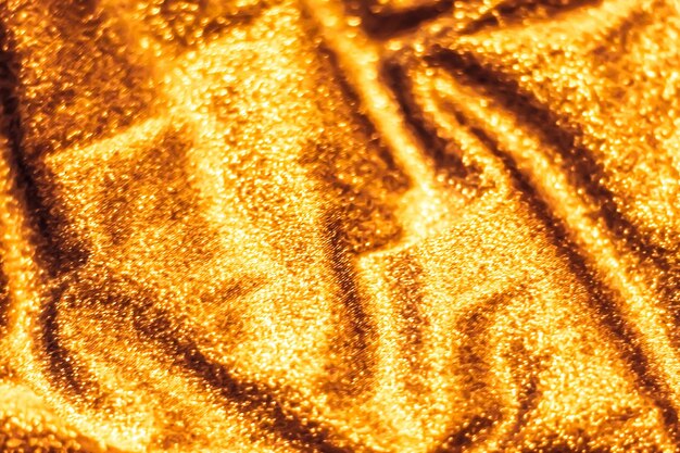 Golden holiday sparkling glitter abstract background luxury shiny fabric material for glamour design and festive invitation