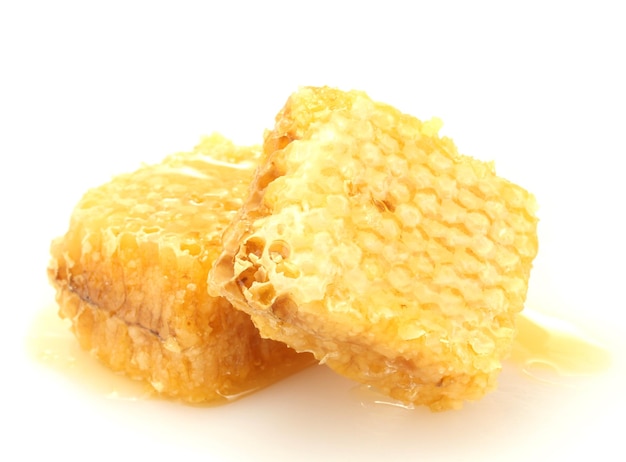 Golden honeycombs with honey isolated on white