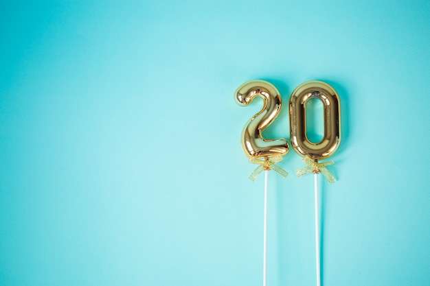 Golden inflated balloons with 20 festive numbers on a blue background.