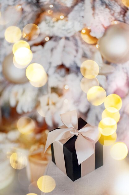 Photo golden lights from the garland inside the gift is a surprise sign of attention for the holiday of