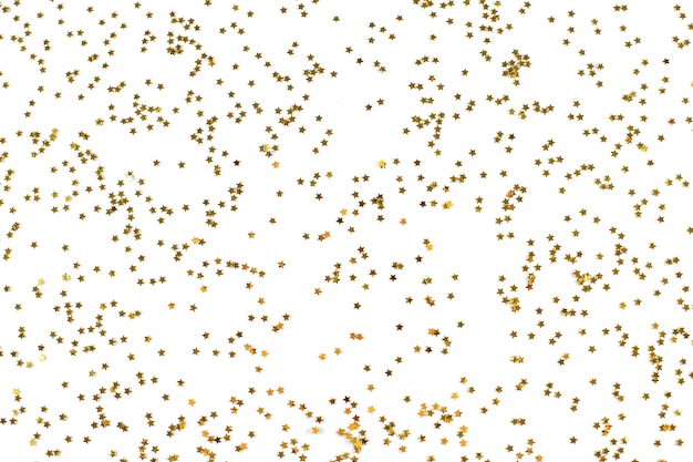 Golden little stars glitter confetti on gray