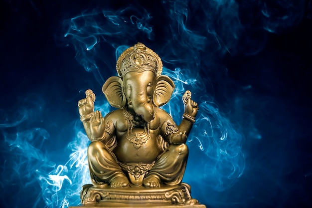 Golden lord ganesha sclupture over dark background. celebrate lord ganesha festival.