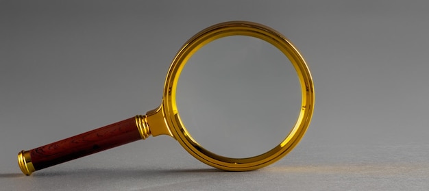 A golden magnifier on black paper background