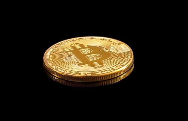 Golden metal bitcoin on a black background